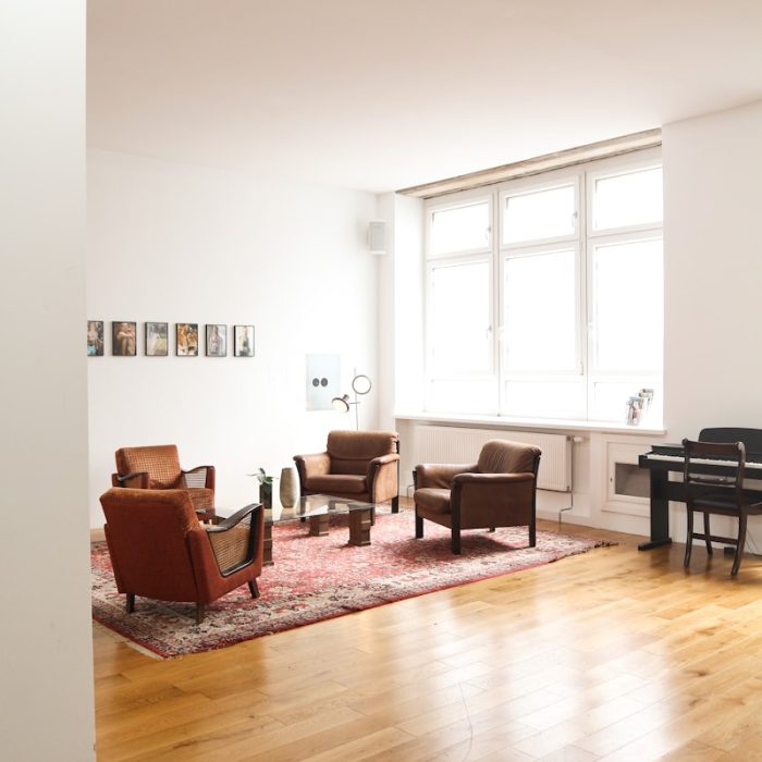 living room with brown wooden parquet floor and white wall